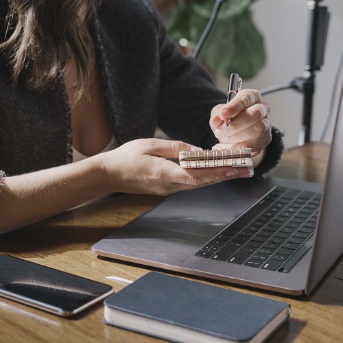 Businesswoman writing on a notebook